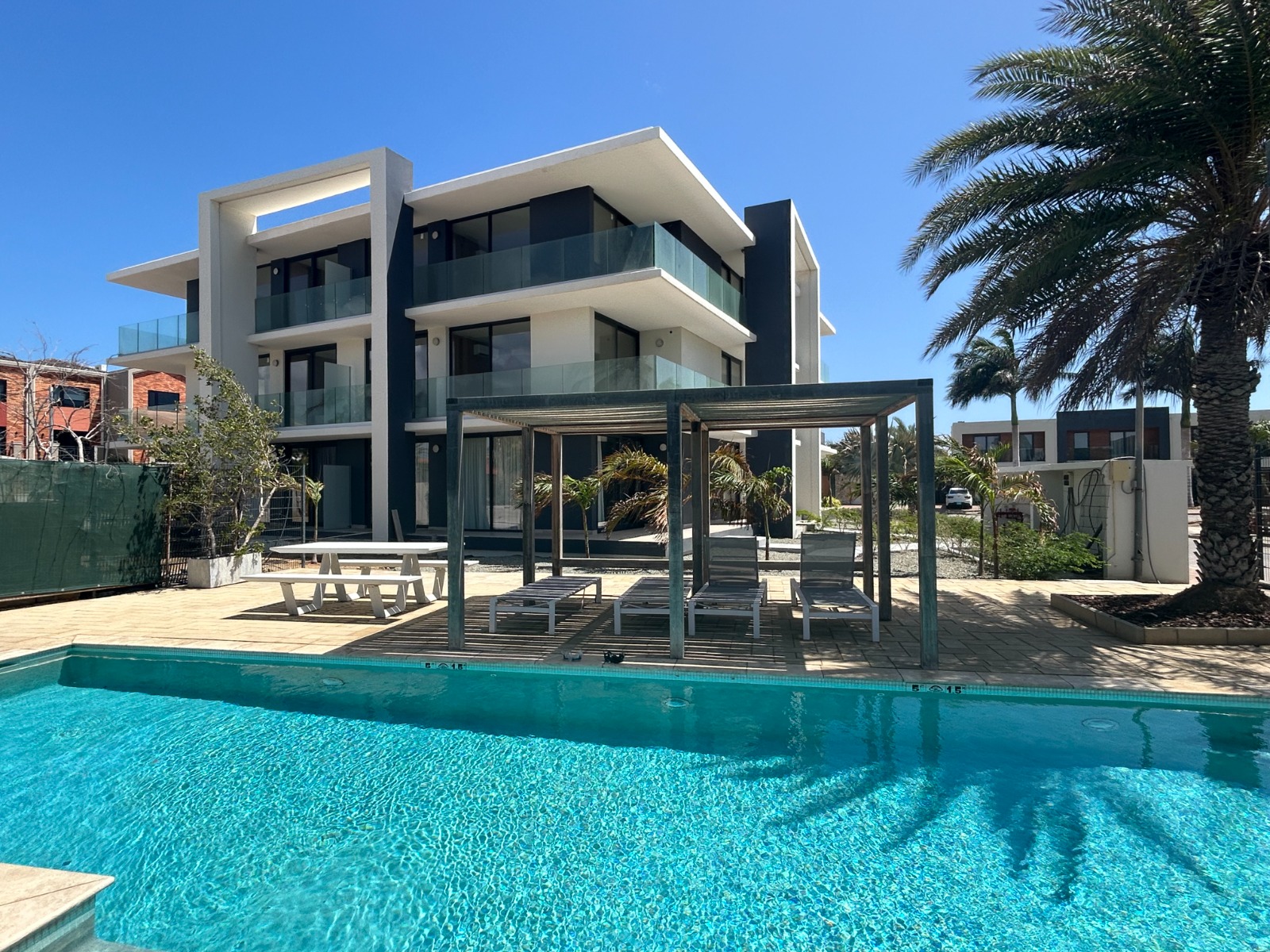 Pool deck with cabana and lounge chairs